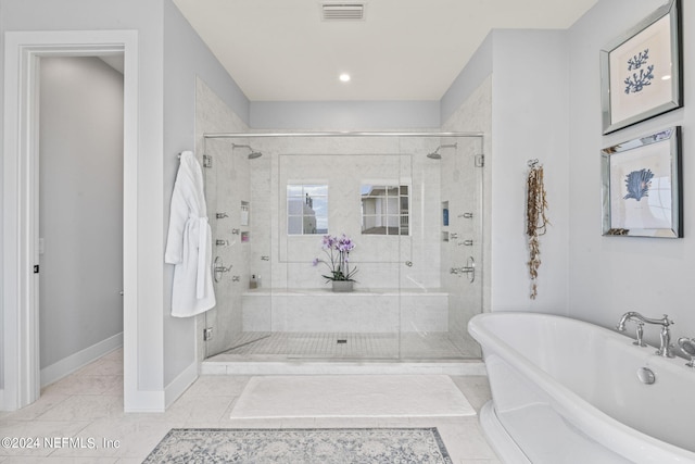 full bathroom with a freestanding bath, a stall shower, and visible vents