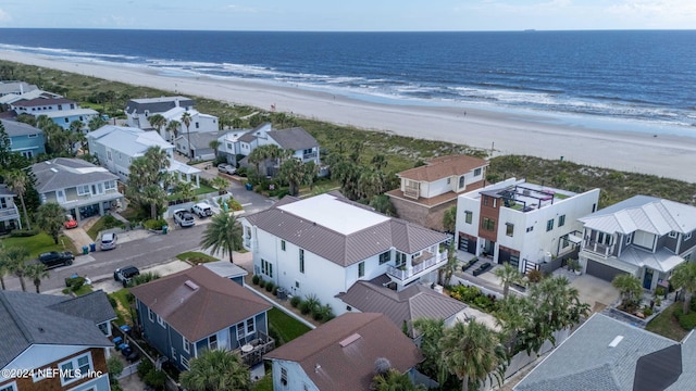 drone / aerial view with a water view, a residential view, and a view of the beach