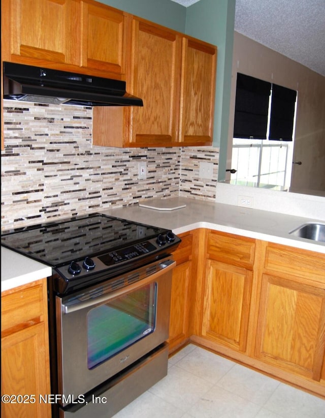 kitchen featuring light countertops, under cabinet range hood, stainless steel electric range, and a textured ceiling