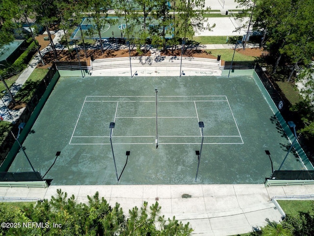 view of sport court featuring fence