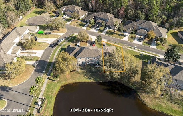 birds eye view of property featuring a water view and a residential view