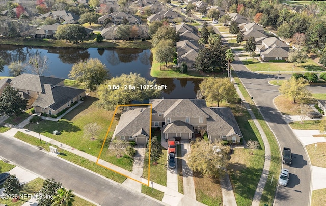 birds eye view of property featuring a water view and a residential view