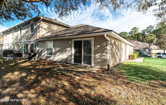 rear view of property with a yard and fence