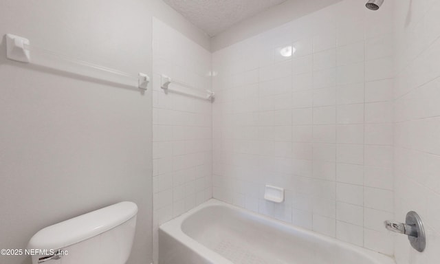 full bathroom featuring a textured ceiling, shower / bath combination, and toilet