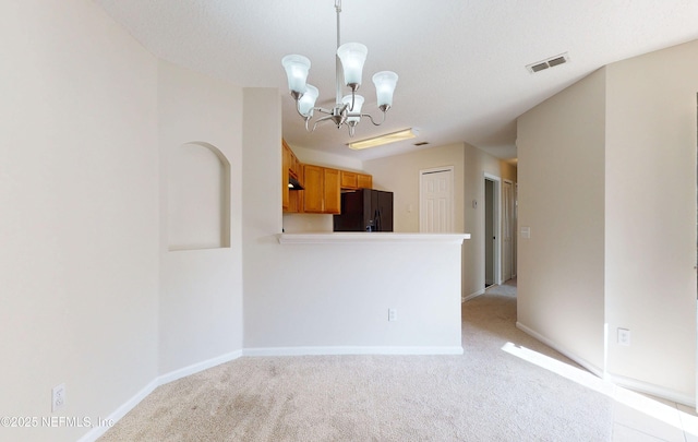 interior space with light carpet, baseboards, visible vents, and an inviting chandelier