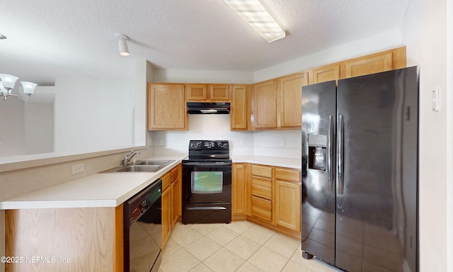 kitchen featuring a peninsula, ventilation hood, light countertops, black appliances, and a sink