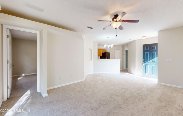 spare room with visible vents, a textured ceiling, baseboards, and ceiling fan with notable chandelier