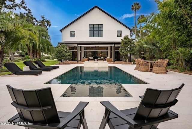 view of pool featuring a pool with connected hot tub and a patio