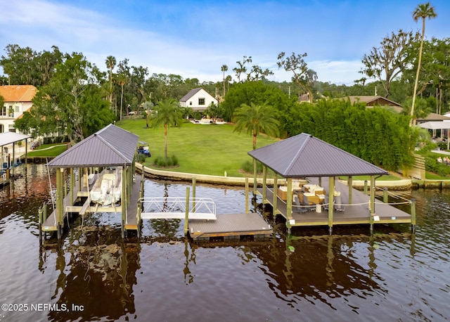 view of dock with a yard, a water view, and boat lift