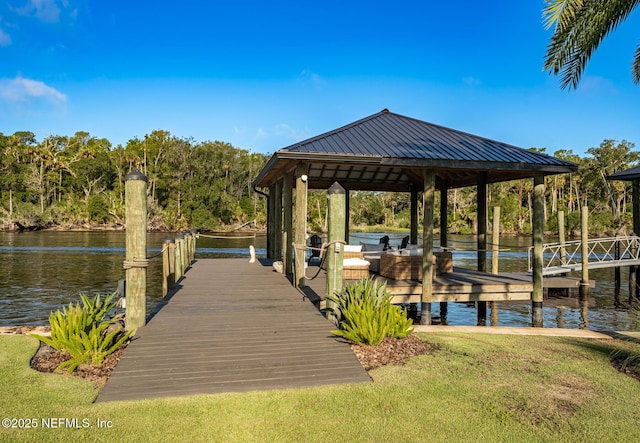 dock area featuring a water view, a lawn, and a gazebo