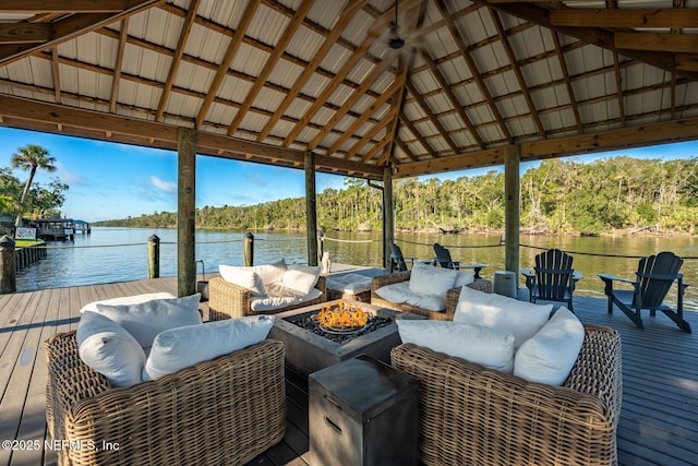 dock area with an outdoor living space with a fire pit and a water view