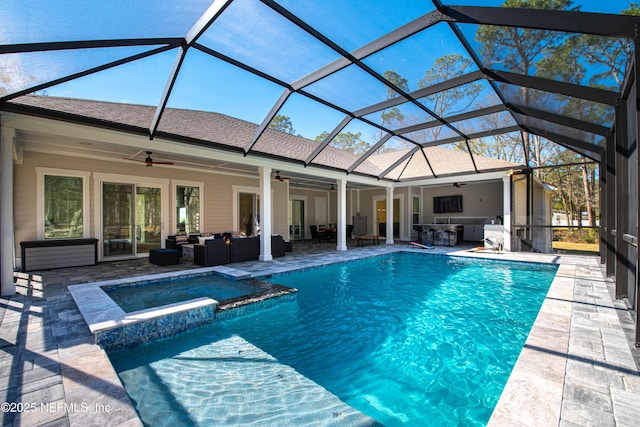 view of pool with a pool with connected hot tub, outdoor lounge area, a patio, and a lanai