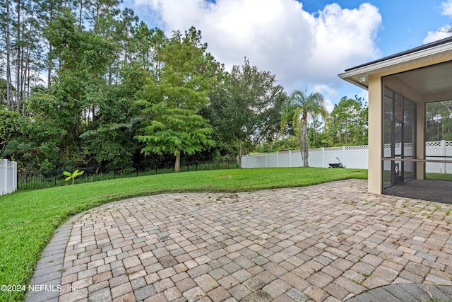 view of patio / terrace featuring a sunroom and a fenced backyard