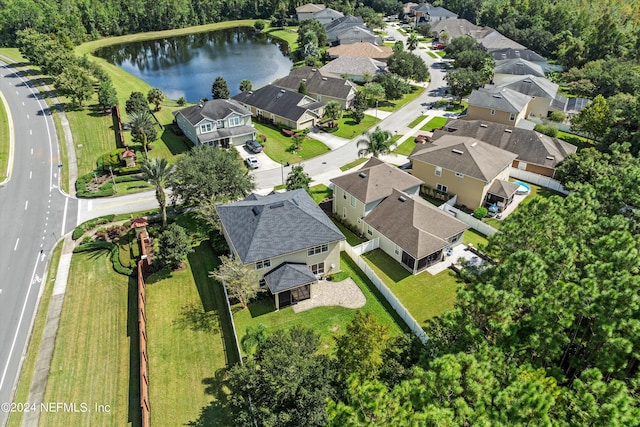 drone / aerial view featuring a water view and a residential view