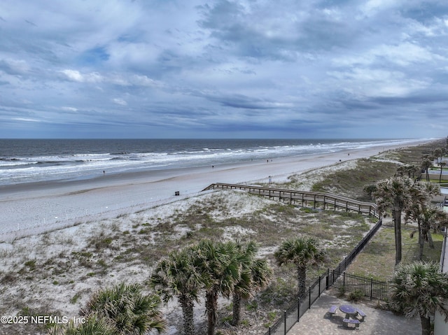water view featuring a view of the beach and fence