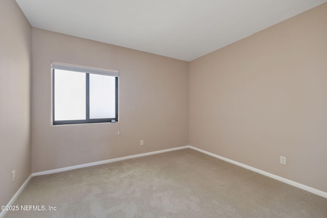 carpeted spare room with baseboards