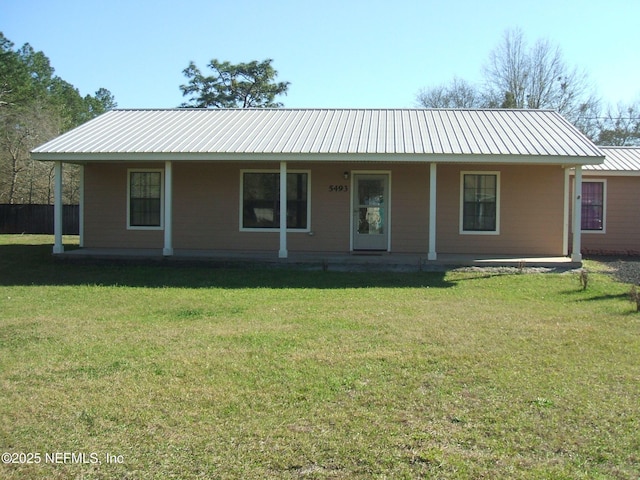 ranch-style home featuring metal roof, a front lawn, and covered porch