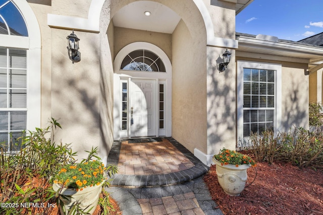 doorway to property with stucco siding