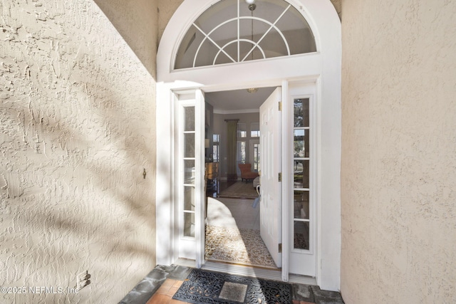 entrance to property featuring stucco siding