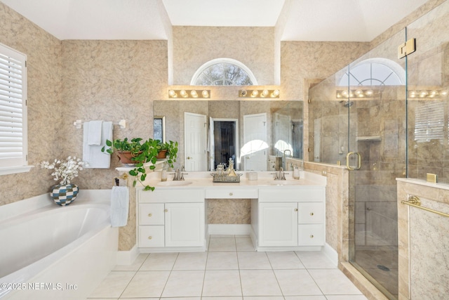 full bathroom with tile patterned flooring, a shower stall, a garden tub, and a sink