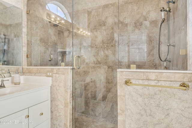 bathroom featuring a shower stall and vanity