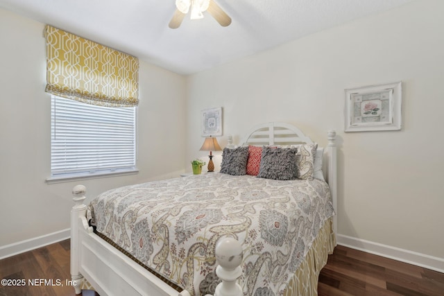 bedroom with a ceiling fan, baseboards, and wood finished floors