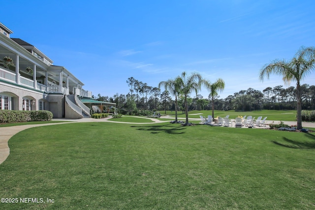 view of home's community with stairway and a lawn