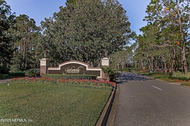 community sign featuring a lawn