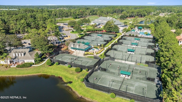 drone / aerial view with a water view and a view of trees