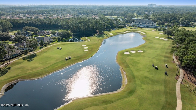 birds eye view of property with view of golf course and a water view