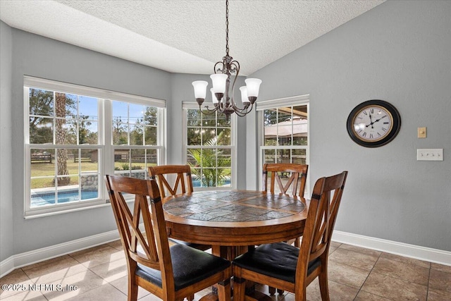 dining area with light tile patterned floors, a textured ceiling, baseboards, vaulted ceiling, and an inviting chandelier