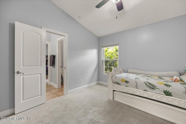 carpeted bedroom with lofted ceiling, a textured ceiling, a ceiling fan, and baseboards