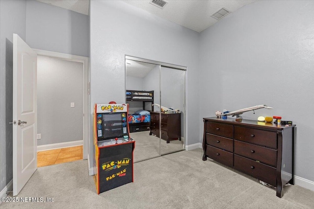 bedroom with carpet floors, a closet, visible vents, and baseboards