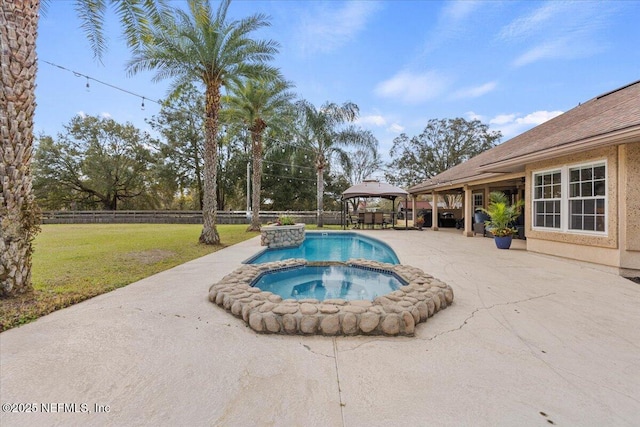 view of pool with a fenced backyard, a pool with connected hot tub, a gazebo, a yard, and a patio area