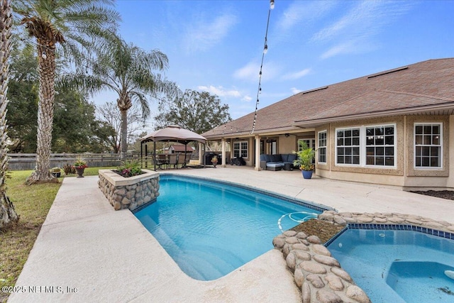 view of swimming pool with a patio, an in ground hot tub, fence, a gazebo, and a fenced in pool