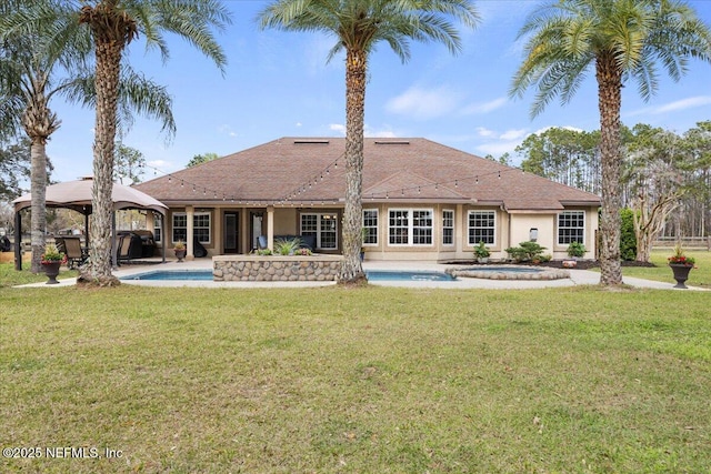 back of house featuring a yard, a patio area, an outdoor pool, and a gazebo