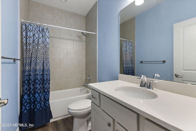 bathroom with toilet, wood finished floors, vanity, and shower / tub combo with curtain