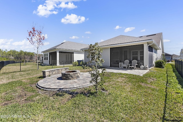 rear view of property with a sunroom, a patio area, a yard, and a fenced backyard