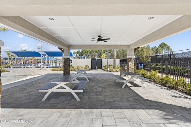 view of patio / terrace with fence and a ceiling fan