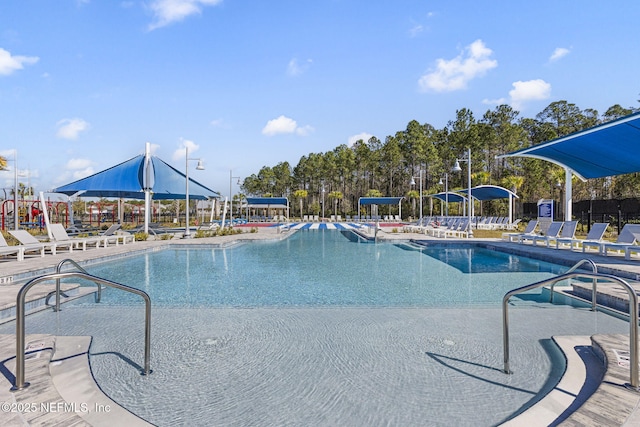 community pool featuring a patio and fence