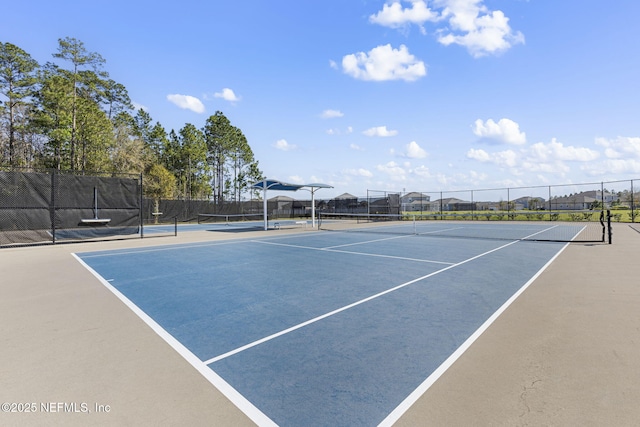 view of sport court featuring fence