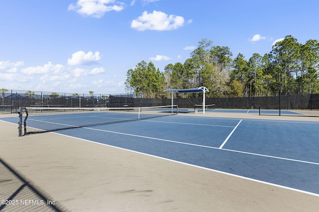 view of sport court featuring fence