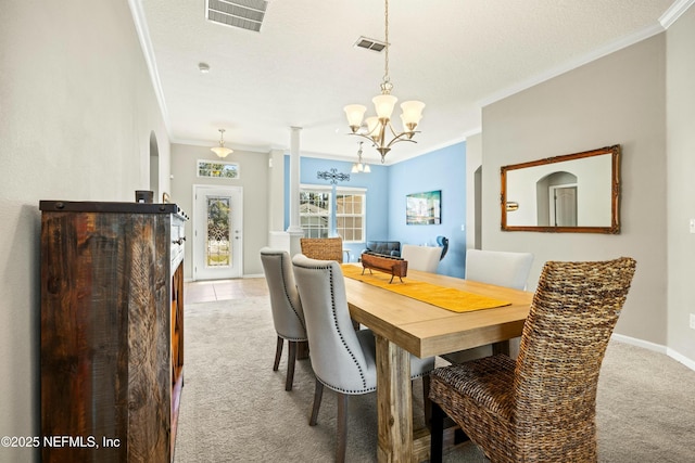 carpeted dining area with baseboards, visible vents, and crown molding