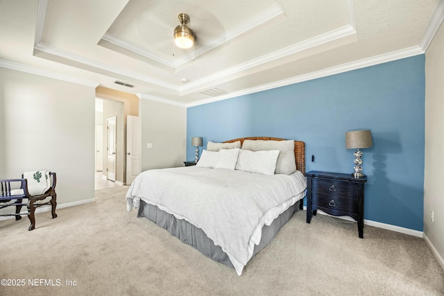 carpeted bedroom featuring baseboards, visible vents, a raised ceiling, and crown molding