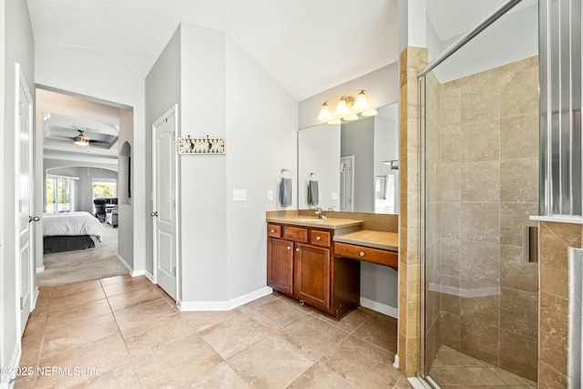 bathroom with baseboards, lofted ceiling, ensuite bathroom, vanity, and a shower stall