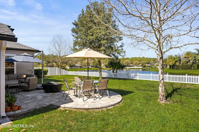 view of yard with an outdoor hangout area, a patio, a water view, and a fenced backyard