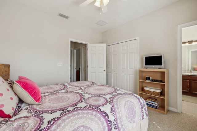 7157 Deerfoot Point Cir Unit 10-2, Jacksonville, FL 32256 - bedroom featuring a closet, light colored carpet, visible vents, a sink, and ensuite bath