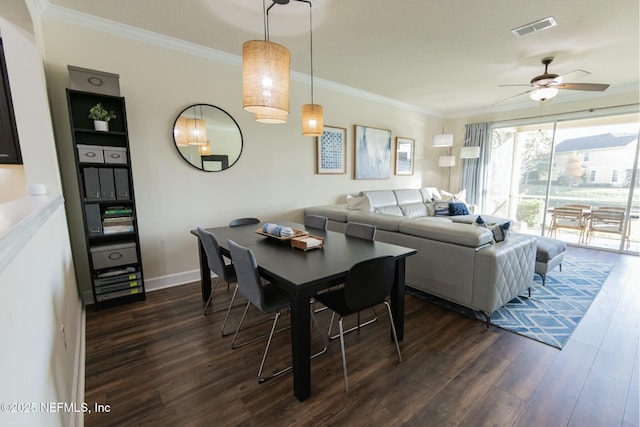 dining room featuring ornamental molding, dark wood-type flooring, and visible vents