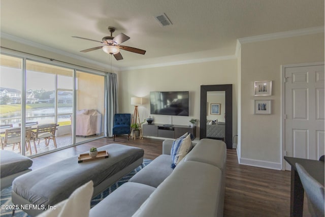 living room featuring baseboards, visible vents, ceiling fan, wood finished floors, and crown molding