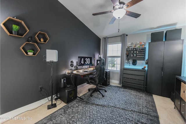 office area with ceiling fan, baseboards, vaulted ceiling, and carpet flooring